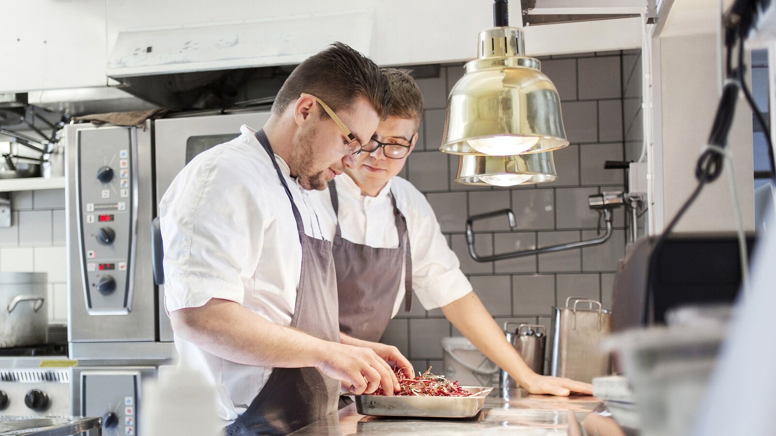 Two chefs in a restaurant kitchen