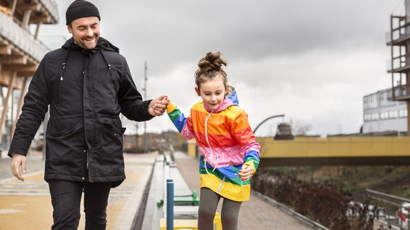 Father and child are out walking.