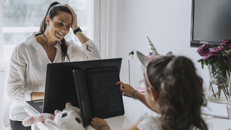 Parent works at home at the kitchen table