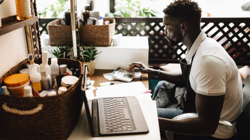 Man at desk with computer and calculator