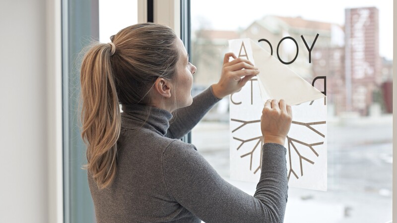 Woman applying window film