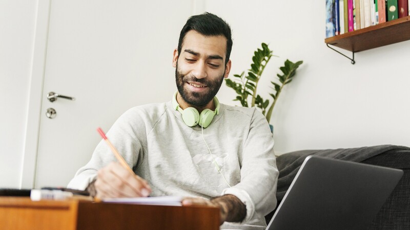 Man writing in a notepad