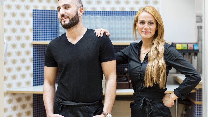  A man and a woman in a cafe environment.