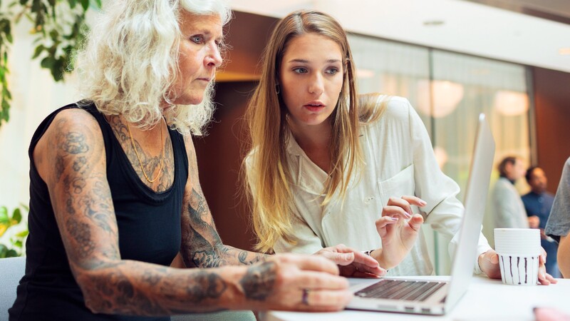 Two women looking at a laptop