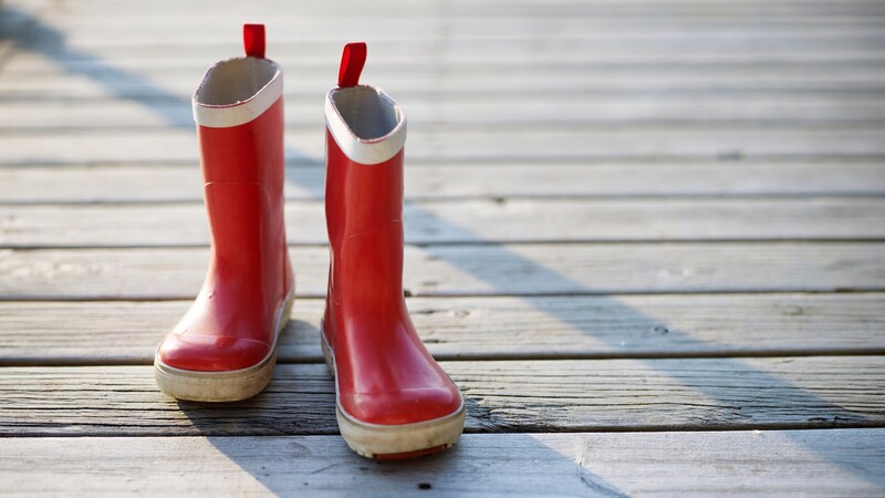 Red rubber boots on pier