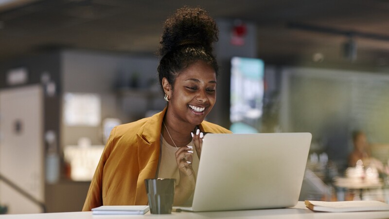 Girl sitting in front of a laptop.