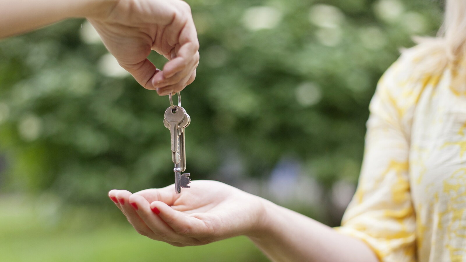 Keys are handed over from one hand to another